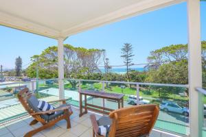 a porch with chairs and a view of a car park at Ocean View Apartments by Kingscliff Accommodation in Kingscliff