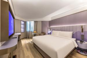 Zhangjiagang Pedestrian Street Manxin Hotel客房内的一张或多张床位