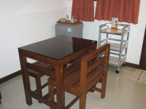 a wooden table and a chair in a room at Residencia Lourdes in Mactan