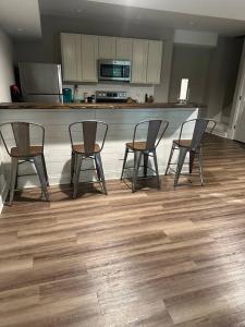 a kitchen with four chairs and a bar with a counter at 2 BR 1 BA apartment in Newnan