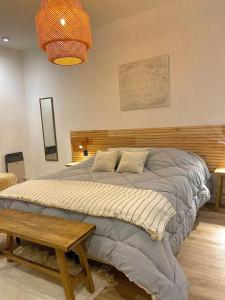 a bedroom with a large bed with a wooden headboard at Magnolia Suites in Nono