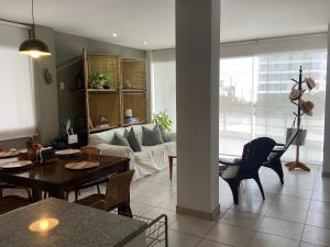 a living room with a couch and a table at Watermanhouse, Punta Hermosa in Lima +21 photos