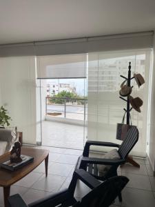 a living room with two chairs and a table at Watermanhouse, Punta Hermosa in Lima