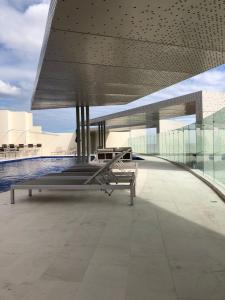 a view of a building with benches on the floor at Habitación Privada Riviera Maya, Playa del Carmen! in Playa del Carmen