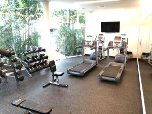 a gym with a bunch of treadms and weights at Habitación Privada Riviera Maya, Playa del Carmen! in Playa del Carmen