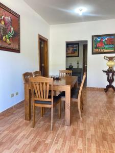 a dining room with a wooden table and chairs at Perfecto para Descansar y Desconectarse Villa Zapata - Apartamentos Turísticos in San Cristóbal