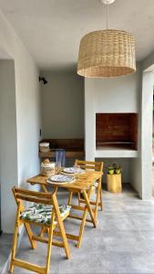 a dining room with a wooden table and chairs at Magnolia Suites in Nono