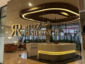 a lobby of a hotel with a sign for the reagan residence at Reizz Residence By Classy in Kuala Lumpur