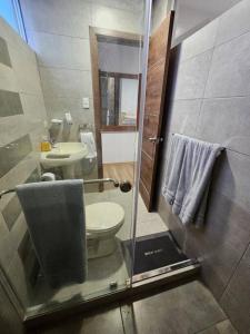 a bathroom with a toilet and a sink at New Dawn Rio in Riobamba