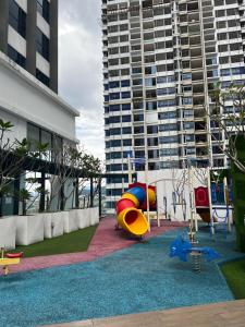 a playground in front of a tall building at Reizz Residence By Classy in Kuala Lumpur