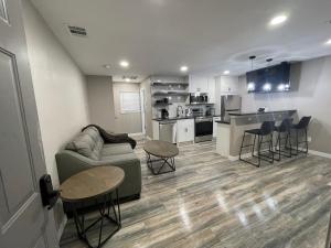 a living room with a couch and a kitchen at Apt 5 - High Plains Lodge at Nomad Landing in Clayton