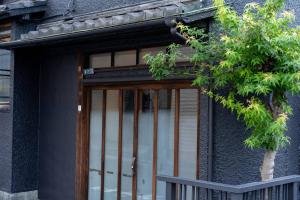 a house with a glass door with a fence at CraftFlat Asakusa House in Tokyo