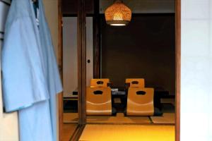 a mirror with two chairs in front of a table at CraftFlat Asakusa House in Tokyo