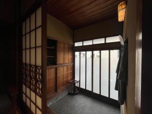 an empty room with a door and a window at CraftFlat Asakusa House in Tokyo