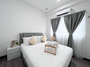 a bedroom with a white bed with a chair on it at Maison Signature Suites in Kuala Lumpur +49 photos