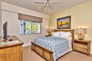 a bedroom with a bed and a desk with a television at Genoa Vacation Rental in Naples +26 photos