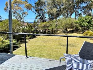 a balcony with a view of a yard at Sea Breeze on Carroll - 4BR beachside home in Mollymook