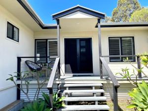 a home with a staircase leading to the front door at Sea Breeze on Carroll - 4BR beachside home in Mollymook