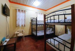 a room with two bunk beds and a desk at RedDoorz @ Johsons Pension House Butuan City in Butuan