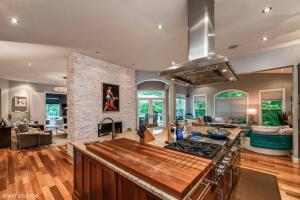 a kitchen with a stove and a living room at Luxury Retreat with Family Feel: Perfect Getaway! in Leesburg