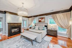 a large bedroom with a bed and a fireplace at Luxury Retreat with Family Feel: Perfect Getaway! in Leesburg