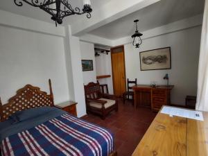 a bedroom with a bed and a table and chairs at Home Sweet Home in Cuernavaca