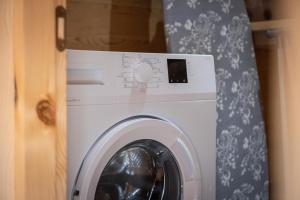 a washing machine in a room with a curtain at Svaneti Countryside 5 in Mestia