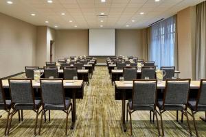 a conference room with tables and chairs and a whiteboard at Courtyard Baltimore Downtown/McHenry Row in Baltimore