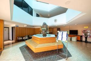 a lobby with a statue in the middle of a building at Mai Khao Beach Condo Hotel by VillaCarte in Mai Khao Beach