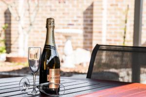 a bottle of wine sitting on a table with a glass at The Terrace in East Ballina