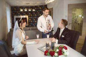 a bride and groom sitting at a table in a restaurant at Lifestyle Beauty & Wellness in Moosbach