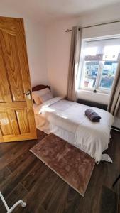 a bedroom with a bed next to a window at Roofers Rest in Magherafelt