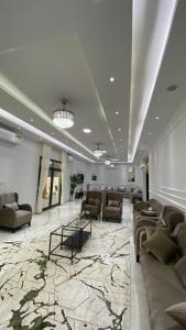 a lobby with couches and a table in a building at دار الضباب dar al dhabab 