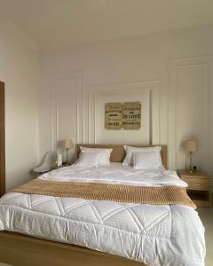 a bedroom with a large bed with white sheets and pillows at دار الضباب dar al dhabab 