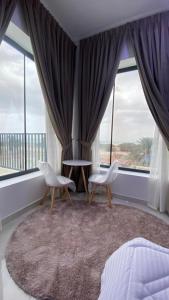 a bedroom with two chairs and a large window at دار الضباب dar al dhabab 