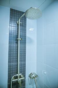 a shower with a shower head in a bathroom at Peony's Home in Ban Don Muang