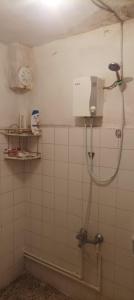 a bathroom with a shower in a tiled wall at Spacious House by the sea , in Gemlik