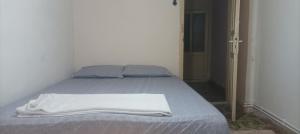 a bed with a white blanket on it in a room at Spacious House by the sea , in Gemlik