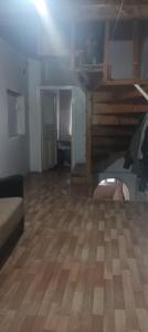 a large room with a wooden floor and a staircase at Spacious House by the sea , in Gemlik