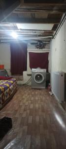a room with a bed and a washing machine in it at Spacious House by the sea , in Gemlik