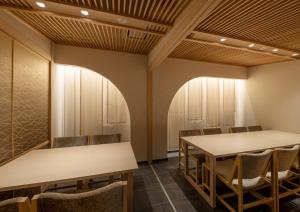 a conference room with two tables and chairs at モダン和風民宿 粋Sui 上野 Asakusa in Tokyo
