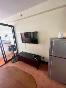 a kitchen with a stainless steel refrigerator in a room at Oasis Homestay (One Oasis Condominium) in Davao City