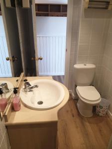 a bathroom with a white sink and a toilet at Ático Montblanc Zona Baja in Sierra Nevada