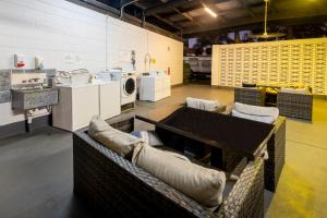 a kitchen with couches and a table in a room at BIG4 Townsville Gateway Holiday Park in Townsville