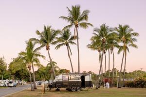 a truck parked in a park with palm trees at BIG4 Townsville Gateway Holiday Park in Townsville