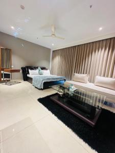 a living room with a bed and a glass table at Luxury Studios Key 1 in Gurgaon