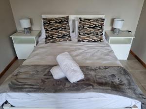a bedroom with a bed with two pillows at Hope Lodge in East London