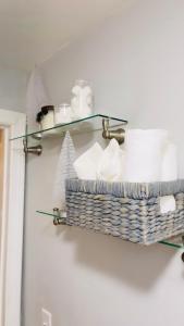a bathroom shelf with a basket of toilet paper at Cargo7 Cozy suites2 in North Providence