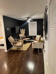 a living room with black walls and wooden floors at Cargo7 Cozy suites2 in North Providence