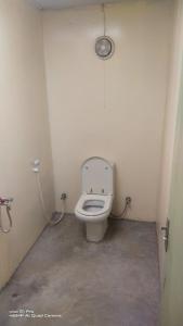 a small bathroom with a toilet in a stall at ONE 7 FARM (DESI PARADISE FARM ) in Dubai